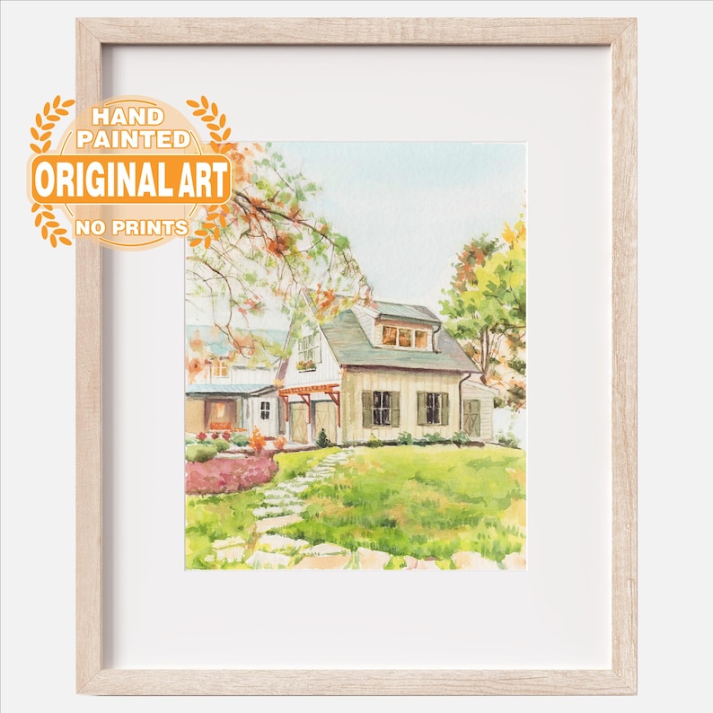 May include: A framed watercolor painting of a house with a light-colored exterior, a green roof, and a stone path leading through a grassy yard. The artwork features a text overlay in the upper left corner that reads HAND PAINTED ORIGINAL ART NO PRINTS.