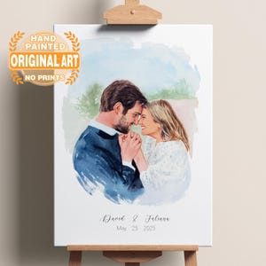 May include: A hand-painted watercolor portrait of a couple, with the text "David & Juliana May 25 2025". The artwork is displayed on an easel, with the words "HAND PAINTED ORIGINAL ART NO PRINTS" in the upper left corner.