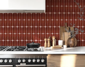 May include: A kitchen scene featuring a black stove and oven with a white countertop. The backsplash is a repeating pattern of red and white elongated ovals. Wooden cutting boards, a vase, and spice grinders are on the counter.