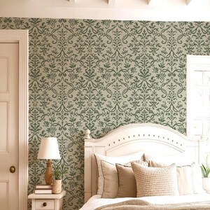 a cozy bedroom with a white wooden headboard, a lamp, and a window. The walls are covered in a patterned wallpaper, and the room has a warm, inviting atmosphere.