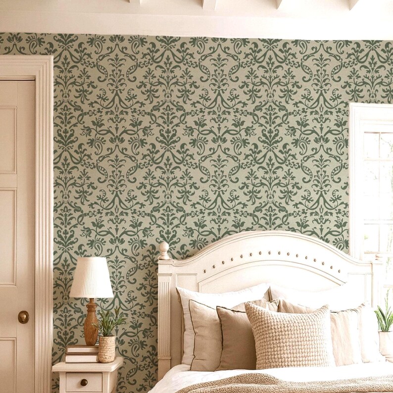 a cozy bedroom with a white wooden headboard, a lamp, and a window. The walls are covered in a patterned wallpaper, and the room has a warm, inviting atmosphere.