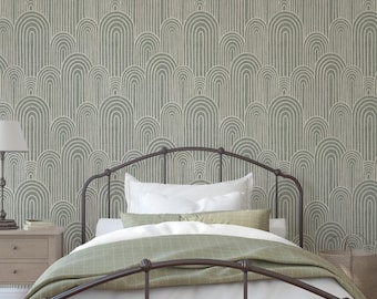 May include: A bedroom scene featuring a dark metal bed frame with white bedding and a green blanket. The wall is covered in a sage green wallpaper with a repeating arched pattern. A nightstand with a lamp is visible.