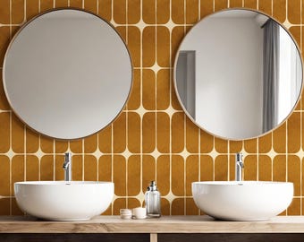 May include: A bathroom vanity with two round mirrors, white vessel sinks, and chrome faucets. The vanity is made of wood and has a shelf with towels, candles, and baskets. The background features a retro-style tile pattern in shades of brown and cream.
