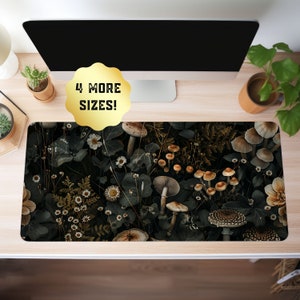 May include: A dark green desk mat with a pattern of mushrooms and white flowers. The mat has a gold border and the text "4 More Sizes!" in a gold circle.