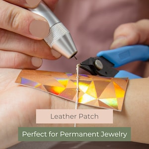 May include: A person is using a tool to attach a silver chain to a holographic leather patch on their wrist. The patch has a geometric pattern and the text "Leather Patch" and "Perfect for Permanent Jewelry" is visible below the patch.