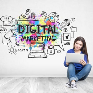 May include: A woman sits on a wooden floor with a laptop in her lap. She is smiling and looking at the laptop. Behind her is a white wall with a colorful drawing of the words "Digital Marketing" and various icons related to online marketing.