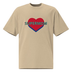 May include: Beige t-shirt with a red heart and the text "SUPERMOM" in teal.