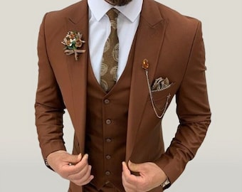 May include: A brown three-piece suit with a patterned tie and a pocket square. The suit jacket has a single button closure and a notched lapel. The vest has a five-button closure. The pants have a straight leg.