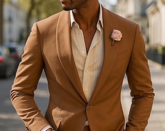 May include: A brown suit with a matching jacket and trousers. The jacket has a shawl collar and a single button closure. A light pink rose is pinned to the lapel. The suit is paired with a striped dress shirt.