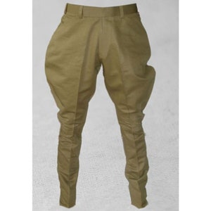 May include: A pair of khaki riding breeches with a belt loop and a zipper fly.