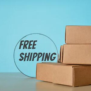 May include: A stack of four brown cardboard boxes on a light-colored surface against a blue background. A circular graphic with the words "FREE SHIPPING" is to the left of the boxes.