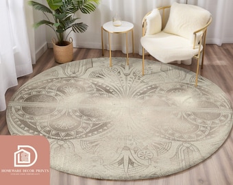 May include: A round, cream-colored rug with a geometric pattern in shades of brown. The rug is placed in a living room setting with a white chair and a gold side table.