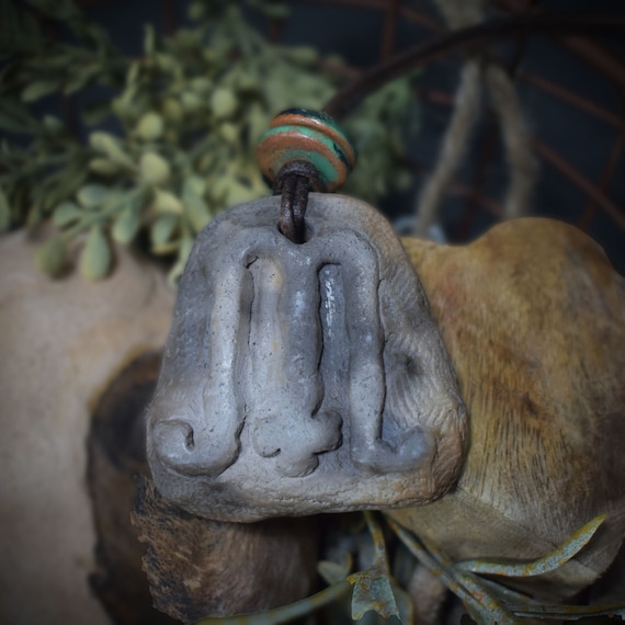 Unique handmade Mabon amulet made of traditionally fired clay - your personal lucky charm with leather or cotton strap
