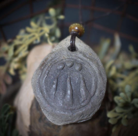 Handmade Awen pendant made of traditionally fired clay with rustic leather or cotton cord