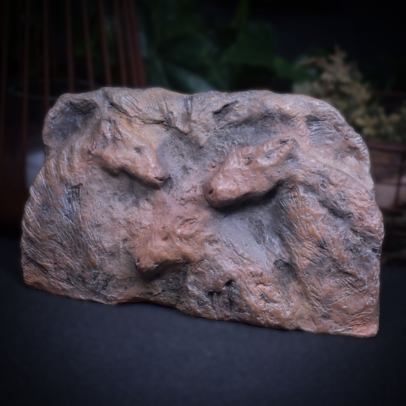 Handmade smoke-fired clay relief inspired by prehistoric cave painting from Lascaux, horses, cave art