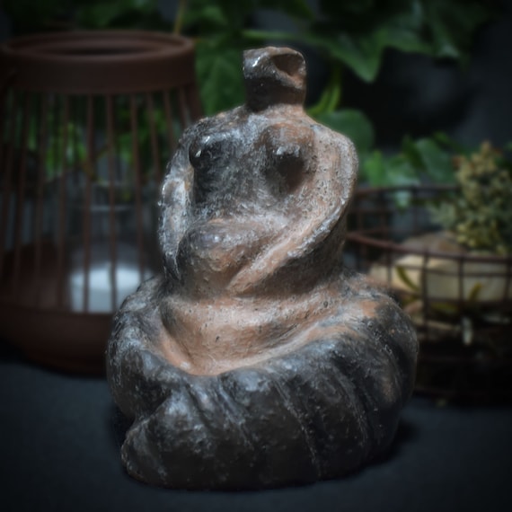 Handmade clay sculpture of the snake goddess - traditional artwork symbol of wisdom and transformation