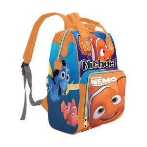 May include: Orange and blue Finding Nemo backpack with a zippered pocket and the name Michael printed on the front.