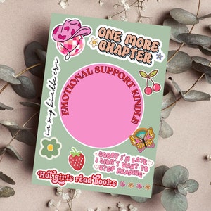 May include: A light green sticker sheet with various colorful illustrations and text. The sheet includes a pink circle with the words "EMOTIONAL SUPPORT KINDLE" and the text "ONE MORE CHAPTER". Other graphics include a cowboy hat, cherries, and a butterfly.