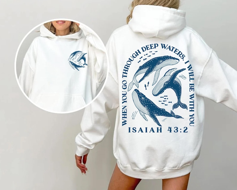 May include: White hoodie with a blue whale graphic and the text "WHEN YOU GO THROUGH DEEP WATERS. I WILL BE WITH YOU ISAIAH 43:2" on the back.