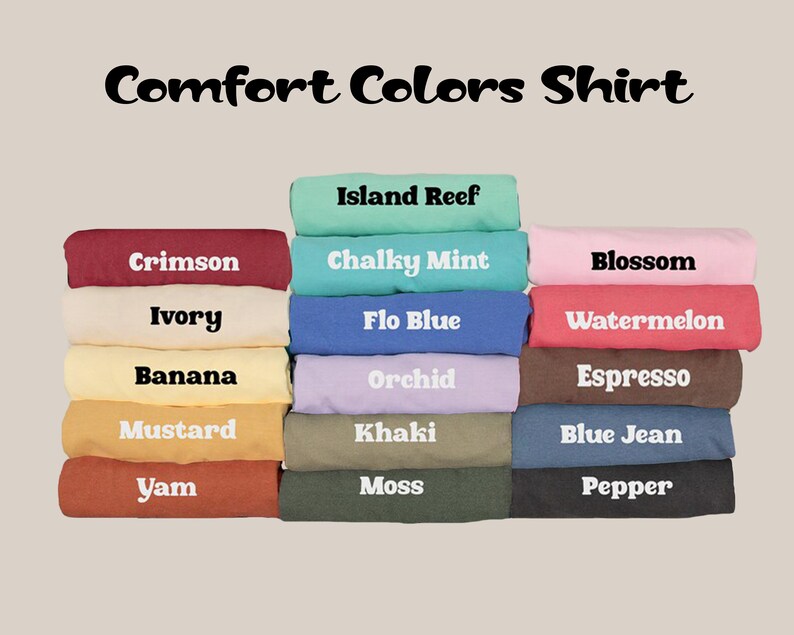 May include: Image of folded Comfort Colors shirts in a range of colours, including Crimson, Ivory, Banana, Mustard, and Yam. Other colours include Island Reef, Chalky Mint, Flo Blue, Orchid, Khaki, Moss, Blossom, Watermelon, Espresso, Blue Jean, and Pepper.