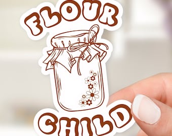 May include: Brown sticker with the text "Flour Child" in a retro font. A hand-drawn illustration of a jar with a lid and a bow, filled with flowers, is between the words.