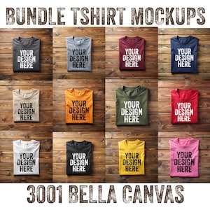 May include: A mockup of 12 folded t-shirts in various colours on a wood background. The text "YOUR DESIGN HERE" is printed on each shirt. The text "3001 BELLA CANVAS" is printed at the bottom of the image.