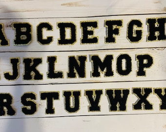 Black Letter Patches with gold trim- Preppy black chenille patches - self adhesive and iron on. 2.2 inches. Great  for your DIY project!