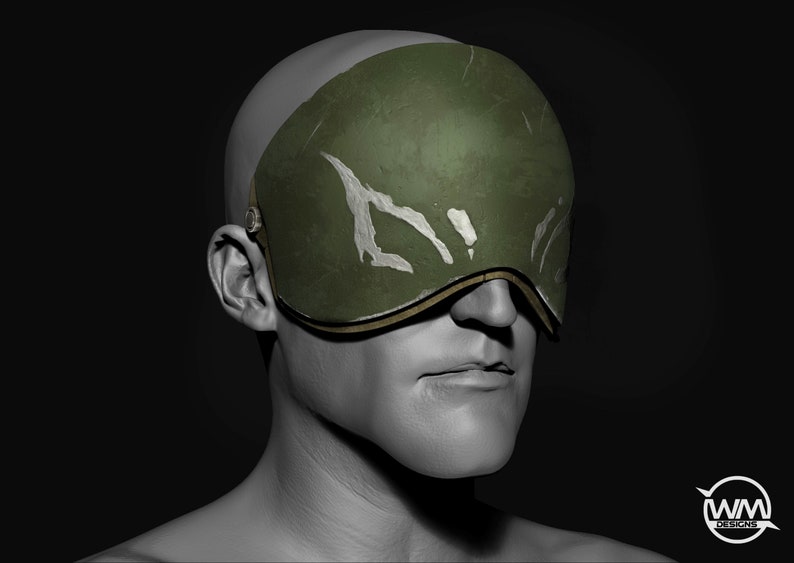 May include: A green eye mask with white markings and a gold trim. The mask is worn over the eyes of a person with a gray face.