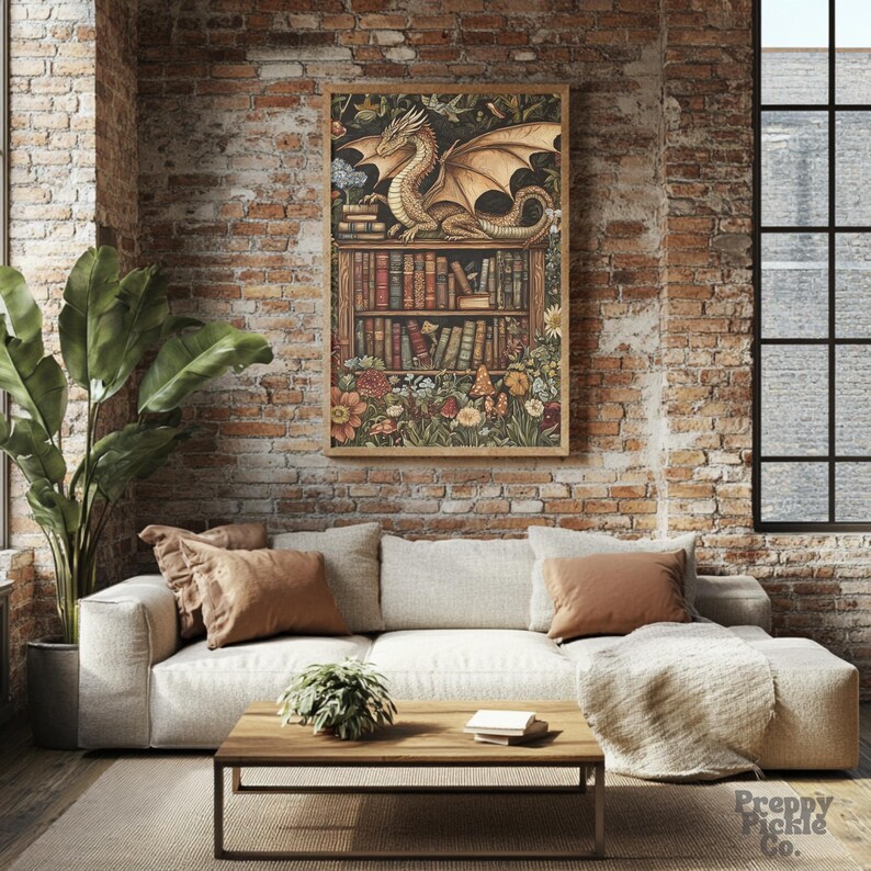 May include: A framed print featuring a golden dragon perched atop a bookshelf filled with books and surrounded by flowers. The artwork has a vintage aesthetic, with a warm color palette and detailed illustrations. The print is displayed in a living room setting.