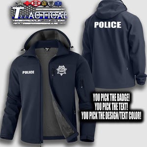 May include: Navy blue softshell jacket with a hood, featuring the word "POLICE" in white on the front and back. A police badge is displayed on the front. The jacket has a zipper closure and multiple pockets. The text "TEE TACTICAL" is at the top.