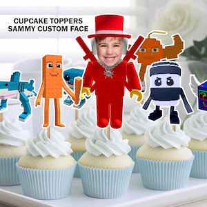 May include: Cupcakes with white frosting and blue liners, topped with custom face and pixelated character toppers. The toppers include a shark, a red figure, and other colorful designs. Text on the image reads "CUPCAKE TOPPERS SAMMY CUSTOM FACE."