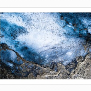 May include: Abstract art print featuring a blue and silver marble design. The background is a light blue with darker blue and silver swirls and streaks.