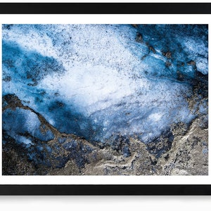 May include: Abstract art print featuring a blue and silver marble-like design. The background is a light blue with darker blue and silver swirls and streaks.
