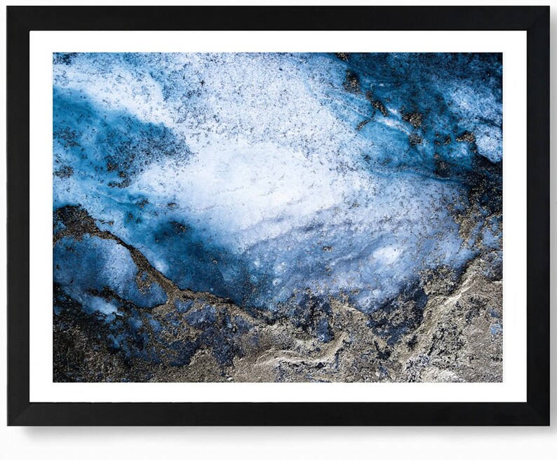 May include: Abstract art print featuring a blue and silver marble-like design. The background is a light blue with darker blue and silver swirls and streaks.