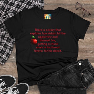 May include: Black t-shirt with red text that reads "There is a story that explains how Adam bit the apple first and blamed Eve, getting a chunk stuck in his throat forever for his deceit."  A red apple with a green leaf is next to the text.