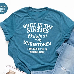 May include: A heather deep teal t-shirt with white text that reads "Built in the Sixties Original & Unrestored Some parts still in working order".