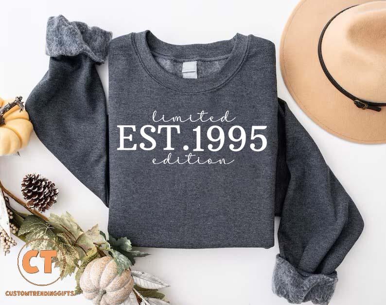 May include: A dark gray sweatshirt with white text that reads "limited EST. 1995 edition".