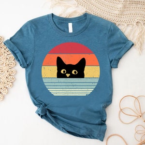 a t - shirt with a black cat on it