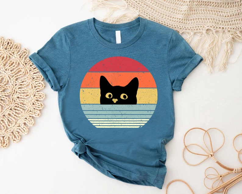 a t - shirt with a black cat on it