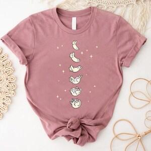 a women's t - shirt with the moon phases on it