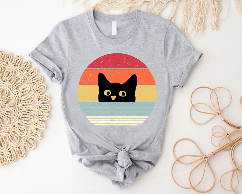 a t - shirt with a black cat on it