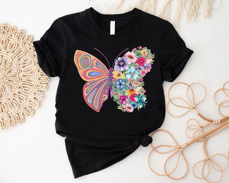 a t - shirt with a butterfly and flowers on it