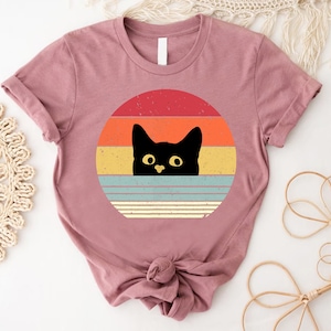 a t - shirt with a black cat on it