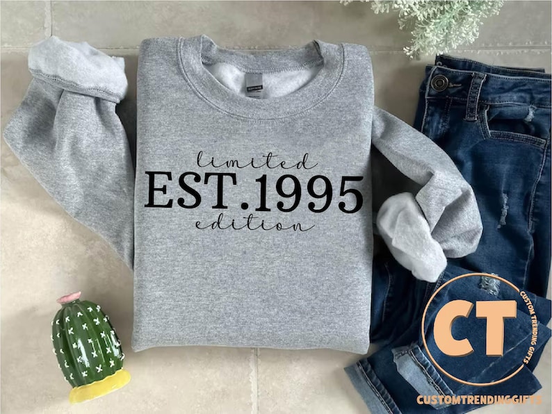 May include: Gray sweatshirt with the text "limited EST. 1995 edition" printed in black.
