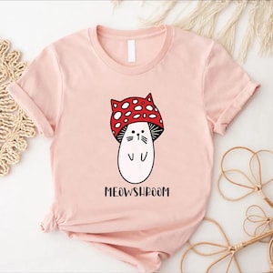 a pink shirt with a cartoon character wearing a red bow