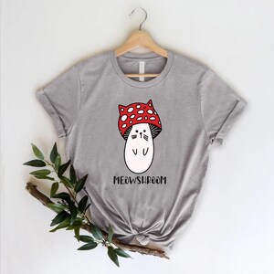 a t - shirt with a mushroom wearing a red bow