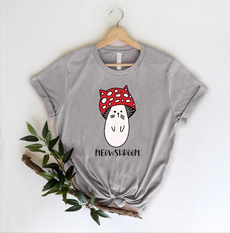 a t - shirt with a mushroom wearing a red bow