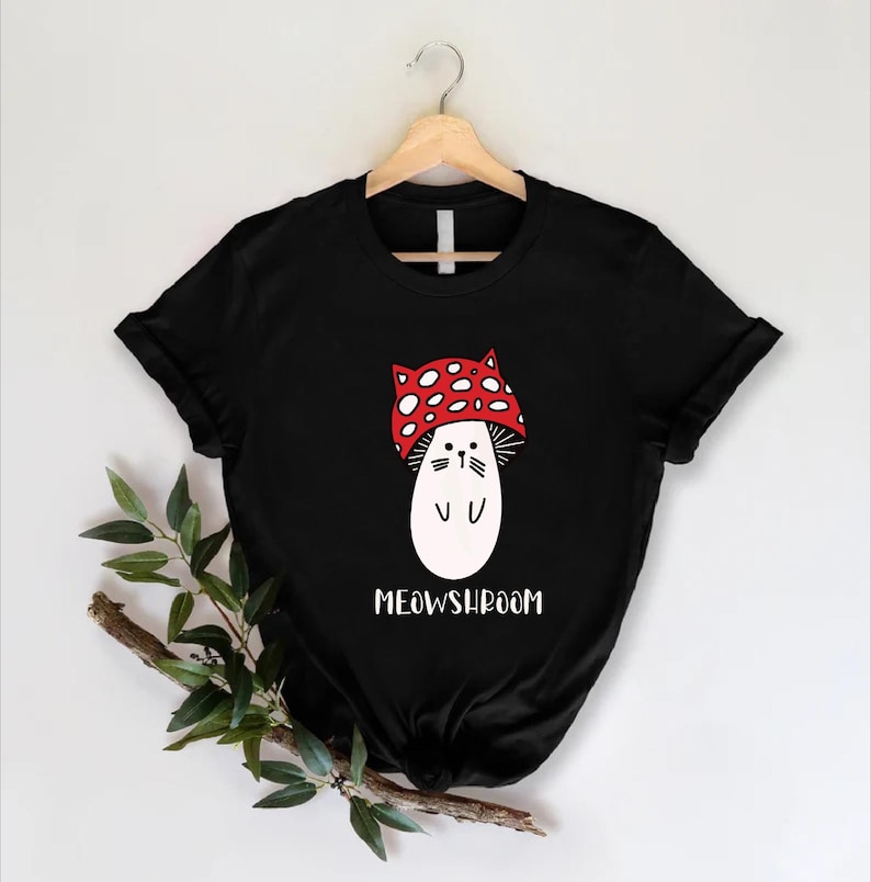 a black t - shirt with a white cat wearing a red bandana