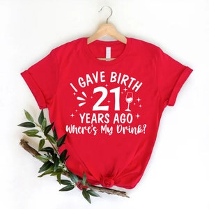a red t - shirt that says i gave birth 21 years ago, where '