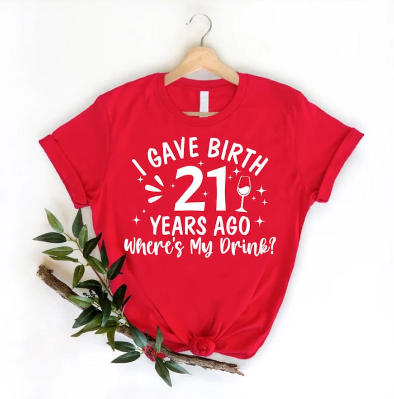 a red t - shirt that says i gave birth 21 years ago, where '